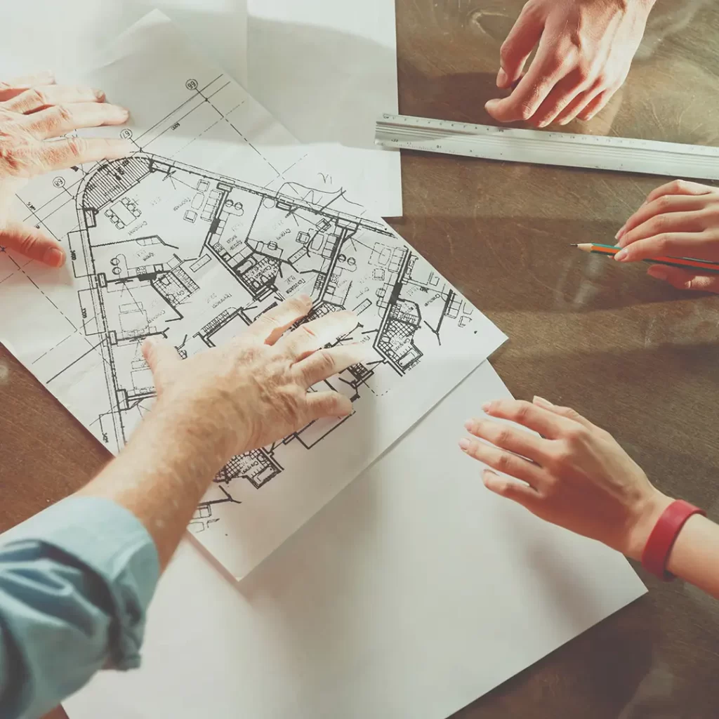 A group of people working on a blueprint.